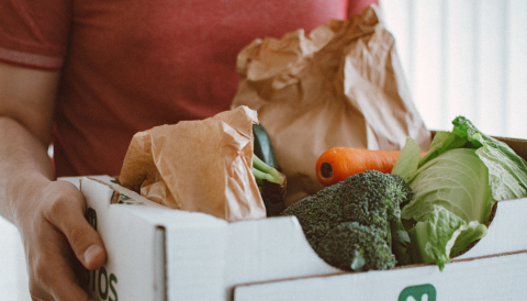 man carrying box of groceries
